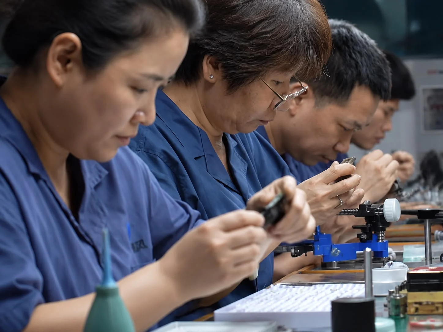 Craftspeople inspecting and working on gemstones